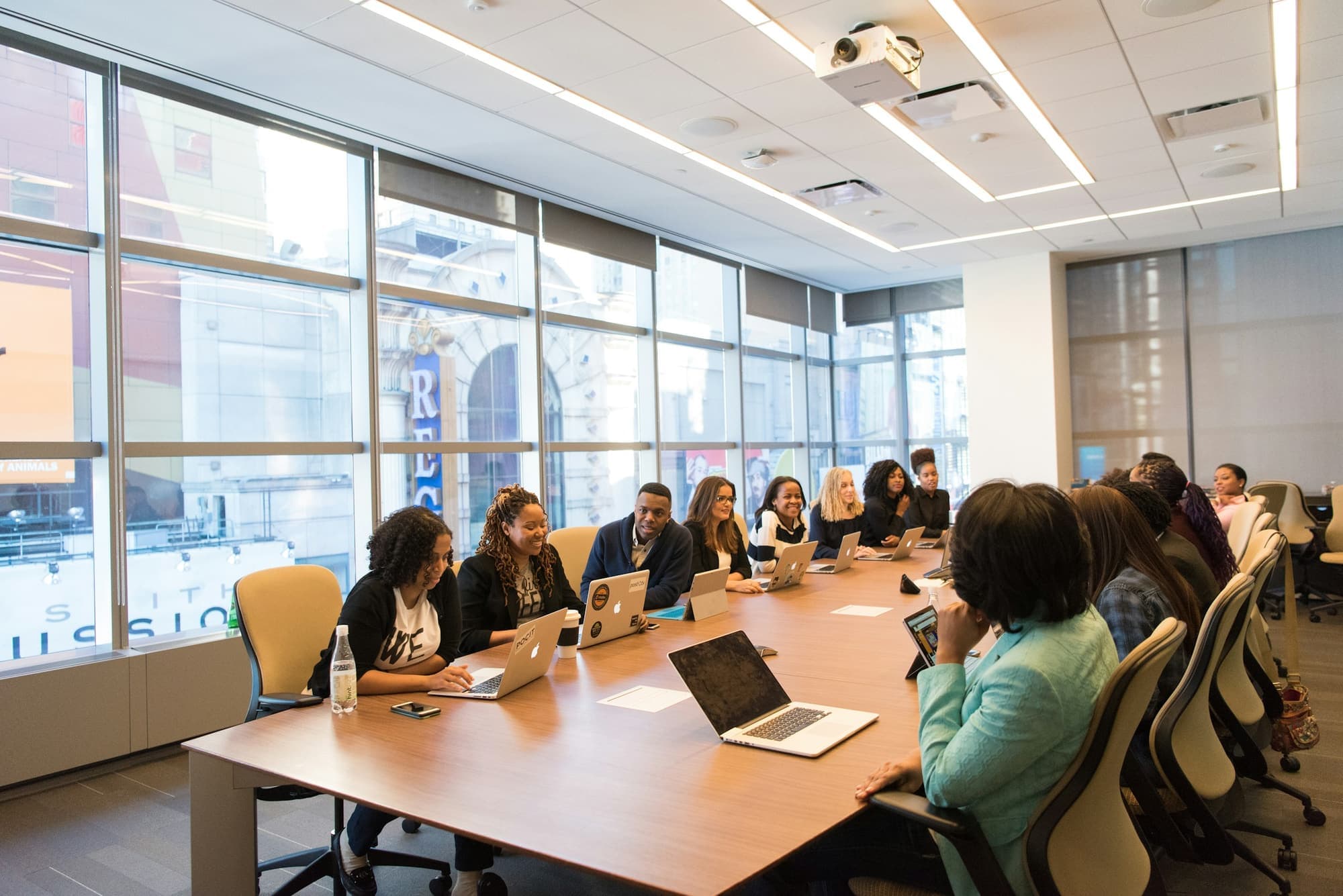 Delegates seated around a long conference table during a working session